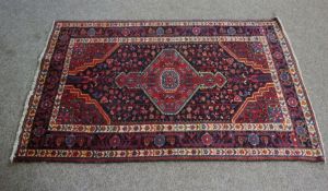 An Iranian Tuisarkhan rug, modern 20th century, with central medallion flanked by flaming altars and