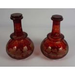 A pair of Victorian flashed ruby glass wine decanters, circa 1880, each of globular form, with