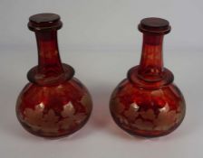 A pair of Victorian flashed ruby glass wine decanters, circa 1880, each of globular form, with