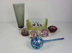 A group of decorative glassware, including three paperweights, a decorative panel with red deer