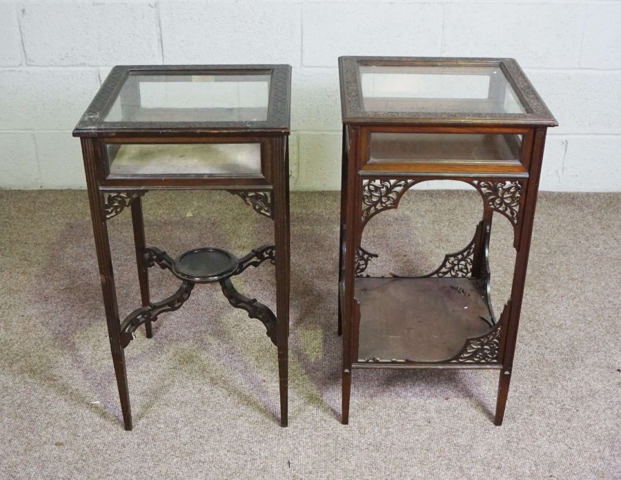 Two similar Edwardian vitrine tables, each with a square hinged and glazed top within blind fretwork