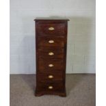 A narrow chest of six short drawers, varnished and with brass lipped cup handles