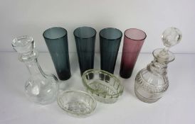 A large assortment of table glass, including four tall smoked glasses, two decanters, brandy glasses