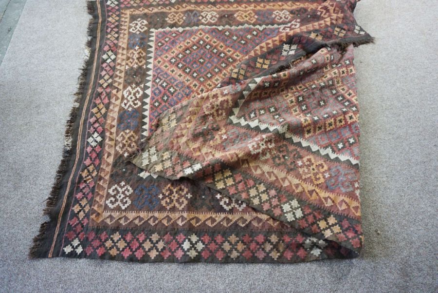 A Kilim rug, 20th century, with geometric lozenges on a brown field, 277cm long, 200cm wide - Image 5 of 6