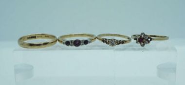 Four rings, including a 9 carat gold, diamond and garnet engagement ring (ring size O), a three