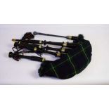 A set of Highland Bagpipes, 20th century, with tartan bag, a chanter, blowpipe, tenor and bass