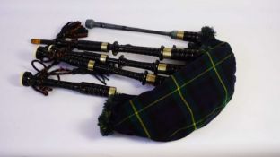 A set of Highland Bagpipes, 20th century, with tartan bag, a chanter, blowpipe, tenor and bass