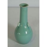 A Chinese porcelain monochrome vase, 20th century, with a light blue glaze, the body with three lugs