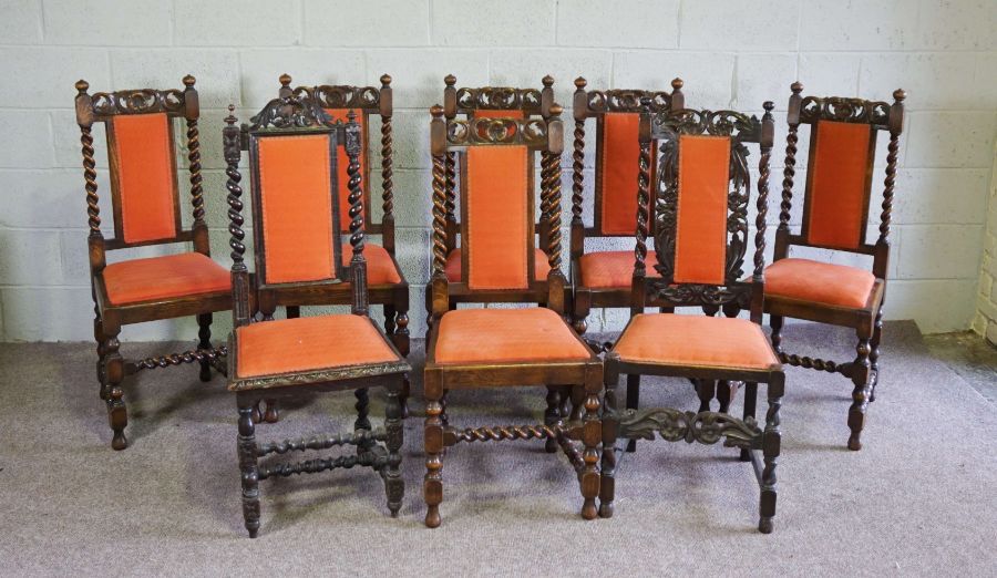 A set of eight Jacobean style oak framed dining chairs, circa 1900, each with a carved crest rail,