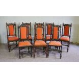 A set of eight Jacobean style oak framed dining chairs, circa 1900, each with a carved crest rail,