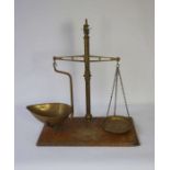 A set of Victorian brass balance scales, stamped Patent Agate, on a mahogany base, 61cm high