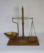 A set of Victorian brass balance scales, stamped Patent Agate, on a mahogany base, 61cm high