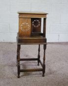 A rotating oak bookstand, circa 1900, with square moulded top, four book compartments with