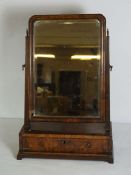 A George II style walnut toilet mirror, with a hinged rectangular mirror in a moulded frame, set