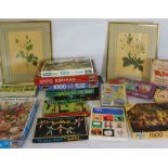 A pair of prints of Roses, after P Redoute, together with a selection of assorted puzzles, including