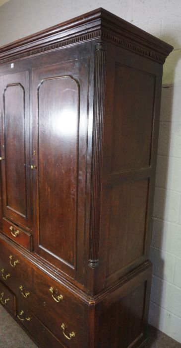 A large George III provincial oak linen cupboard, mid 18th century, with a dentil cornice over three - Image 6 of 7