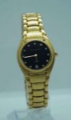 An Aston Gerrard gold plated and diamond ladies watch, the black face set with diamond markers and