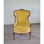 A Louis XV revival beech wood framed and upholstered bergere armchair, early 20th century,  with a