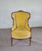 A Louis XV revival beech wood framed and upholstered bergere armchair, early 20th century,  with a