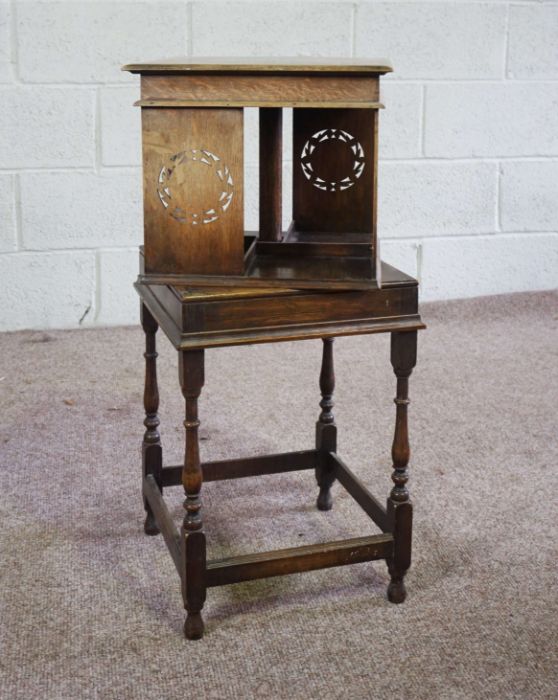 A rotating oak bookstand, circa 1900, with square moulded top, four book compartments with - Image 2 of 4