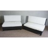 A pair of modern outdoor black plastic rattan style settees, 122cm wide, 85cm high, 83cm deep. (Sold