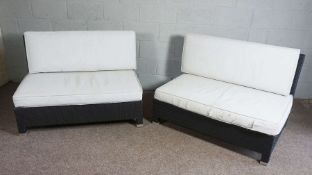 A pair of modern outdoor black plastic rattan style settees, 122cm wide, 85cm high, 83cm deep. (Sold