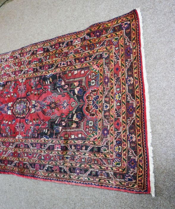 A small Iranian Tuisarkhan rug, modern, 20th century, with single central medallion on a floral blue - Image 3 of 4