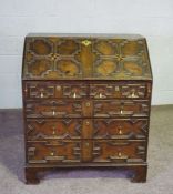 A Jacobean style oak bureau, 19th century revival, with a geometric moulded fall front, with boxwood