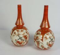 A pair of Japanese Kutani vases, Meiji period, with panels of birds within orange borders, red