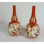 A pair of Japanese Kutani vases, Meiji period, with panels of birds within orange borders, red