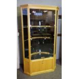 A bespoke birch framed jewellery shop corner cabinet, fitted with two deep glass shelves, with a