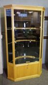 A bespoke birch framed jewellery shop corner cabinet, fitted with two deep glass shelves, with a