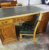 An oak George III style partners desk, 20th century, with leather inset top over arrangement of nine