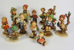 A group of twelve assorted Goebel & Hummel figurines, including Skier & Apple Tree Boy (12)