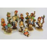 A group of twelve assorted Goebel & Hummel figurines, including Skier & Apple Tree Boy (12)