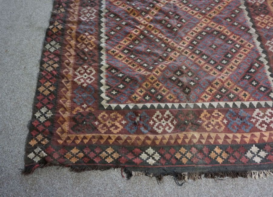 A Kilim rug, 20th century, with geometric lozenges on a brown field, 277cm long, 200cm wide - Image 4 of 6