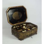 A Chinese Export lacquered sewing box, circa 1880, Qing Dynasty, of octagonal form, with a hinged