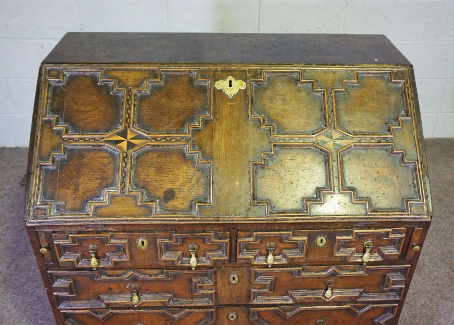 A Jacobean style oak bureau, 19th century revival, with a geometric moulded fall front, with boxwood - Image 5 of 6
