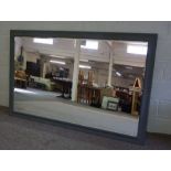 A large wall mirror, modern, with bevelled rectangular plate within a moulded grey painted frame,