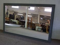 A large wall mirror, modern, with bevelled rectangular plate within a moulded grey painted frame,