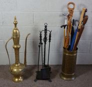 A large Persian brass ewer, 93cm high; together with a brass stick stand, including assortment of