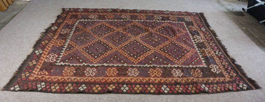 A Kilim rug, 20th century, with geometric lozenges on a brown field, 277cm long, 200cm wide - Image 2 of 6