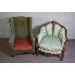 A Victorian varnished oak and button upholstered salon armchair, with a deep seat, carved and