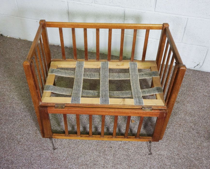 A child’s cot, mid 20th century, with slatted and folding sides, including a small mattress (used as - Image 2 of 4