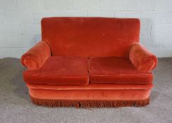 A small red two seat sofa, with scrolled arms and tassel fringe, 153cm wide; together with three