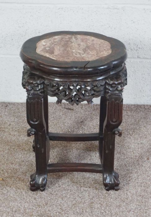 A Chinese hongmu and stone topped vase pedestal, Qing dynasty, with carved decorative frieze, the