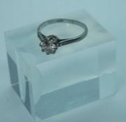 A diamond and platinum set engagement ring, the brilliant cut central diamond (approx 1.07