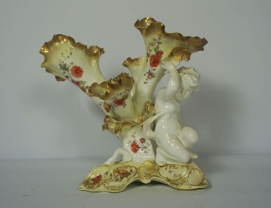 A quantity of decorative ceramics, including a fine Moore Bros table centrepiece with putti