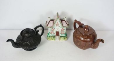 Two 19th century tea pots, including a large Victorian salt glaze example, impressed ‘a present from