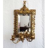 A Baroque brass framed girandole, late 19th century revival, with a bevelled rectangular mirror